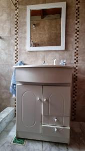 a bathroom with a sink and a mirror at Rancho Aparte in Ituzaingó