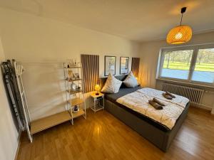 a bedroom with a bed with two dogs laying on it at Feel like Home 3 in Biberach an der Riß