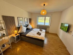 a bedroom with a bed with a dog on it at Feel like Home 3 in Biberach an der Riß