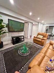 a living room with a large television and a couch at SUITE A 2 Bedroom Apartment in Brampton