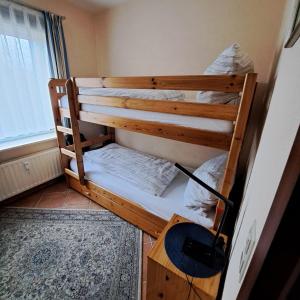 a bunk bed in a room with a desk at Apartment Wiesener in Büsum