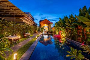 a swimming pool in a villa at night at Alana Homestay Hoi An in Hoi An