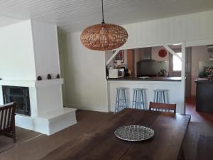 a living room with a table and chairs and a kitchen at villa les Arbousiers in Vieux-Boucau-les-Bains +16 photos