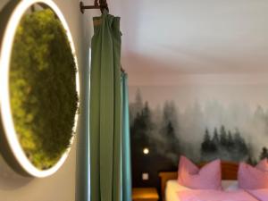 a room with a green wreath on the wall at Schwarzwald-Hotel Kraeutle in Feldberg