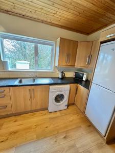 a kitchen with a washer and dryer in a house at Crega Cottage in Malin Head