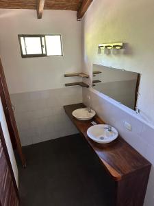 a bathroom with two sinks and a mirror at Surfing Turtle Lodge in Poneloya +46 photos