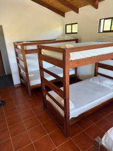 a group of bunk beds in a room at Surfing Turtle Lodge in Poneloya