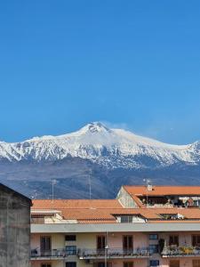 a view of a snow covered mountain from a building at B&B Ai piedi dell'Etna in Acireale