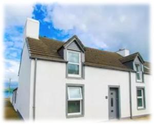 a white house with a brown roof at Lochside Retreat, Stranraer - Cottage by the loch! in Stranraer