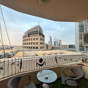 a balcony with tables and chairs and a view of a city at شقة غرفة وصالة بلكونه دخول ذكي in Riyadh