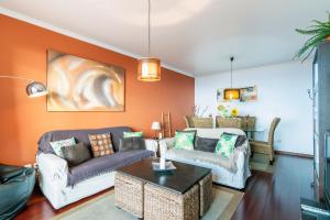 a living room with two couches and a table at Barcelos Apartment by HR Madeira in Funchal