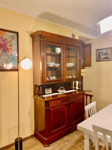 a large wooden cabinet in a dining room at Casa Vacanze Il Borgo in Gubbio