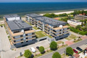 an aerial view of a large building next to the ocean at GARDENIA BLUE APART Dziwnów z widokiem na morze in Dziwnów