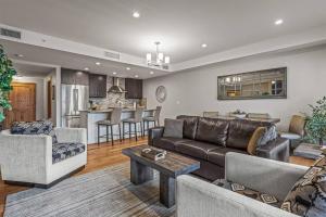 a living room with a couch and a table at Spring Creek Spacious Luxury & Views at White Spruce Lodge in Canmore