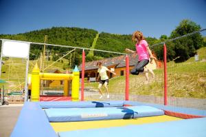two people jumping on a trampoline at Residence Hotel & Club in Donovaly