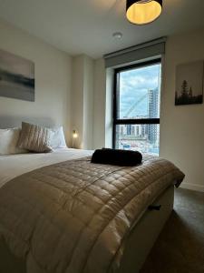 a bedroom with a large bed with a large window at Luxury Apt in Wembley Park Perfect for Events & Exploring London in London