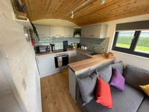 a kitchen and living room in a tiny house at Maple Lodge Quirky Salvaged Railway Carriage with Hot Tub in Boston