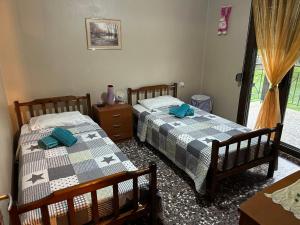 A bed or beds in a room at ''Mary's House'' Entire residence Olympiada Halkidiki Near to Sea 200m !