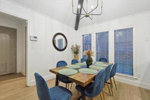a dining room with a table and chairs and a mirror at Beautiful 5BR 2BA DeSoto Holiday Home with Pool in DeSoto