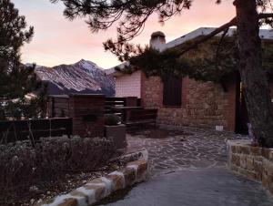 a stone house with a bench in front of it at La Kumari in Pintura di Bolognola +30 photos