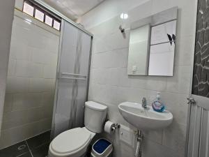 a bathroom with a toilet and a sink and a shower at tour & hosteleria moonlight in Villavieja