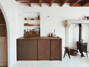 a kitchen with a wooden island in a room at Maison Magda in Ambierle