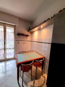 a kitchen with a ping pong table and two chairs at La Ludocanda in Turin