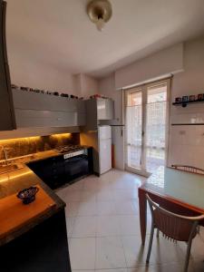 a kitchen with a table and a stove top oven at La Ludocanda in Turin