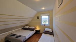 1 dormitorio con 2 camas y ventana en Parysówka Noclegi w Rzeczce Góry Sowie en Walim