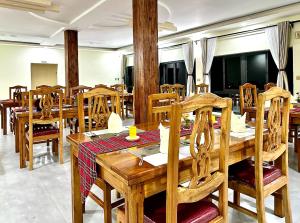 a dining room with wooden tables and chairs at OLORIEN MARA CAMP in Masai Mara