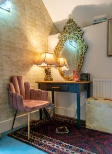 a dressing table with a chair and a mirror at Luxurious, Fabulous, Fun, Contemporary Suite in Retreat Centre in Salisbury