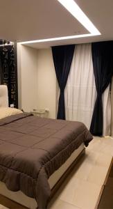 a bedroom with a large bed with black curtains at جامعه الدول مهندسين in Cairo