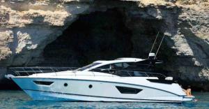 a white boat in the water next to a cave at Boat For Events in Naples