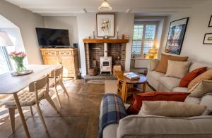 a living room with a couch and a table at Dene Croft Cottage in Hexham