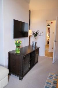 a living room with a flat screen tv on a wall at Avon's View in Stratford-upon-Avon