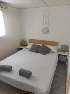 a bedroom with a large white bed with two pillows at Bungalow, Sueños del Sur! in Chiclana de la Frontera +22 photos