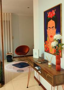 a living room with a painting of a woman on the wall at RR Residence in Viana do Castelo