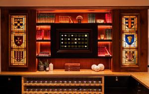 a bar with stained glass windows in a library at Hôtel Les Armures in Geneva