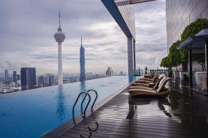 a swimming pool on top of a building with a city at SKYWARD SUITE KLCC in Kuala Lumpur