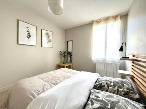 een slaapkamer met een wit bed en een raam bij Appartement de standing- hyper centre in Sens