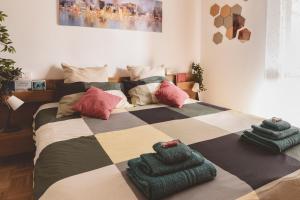 a bedroom with a large bed with pillows on it at Casa Zoe 2 Apartment(Parking,Self Check-in & Wi-Fi) in Parma