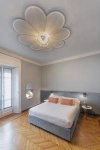 a bedroom with a large bed with a large flower ceiling at Fifty Eight Suite Milan in Milan