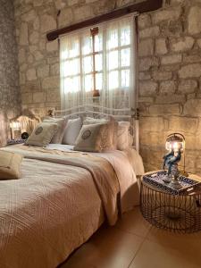 a bedroom with a large bed and a window at Florence Dreaming House in Pissouri