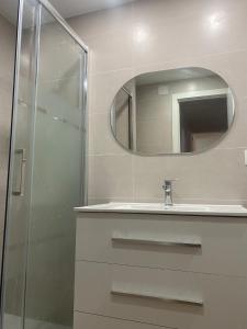 a bathroom with a sink and a mirror at Castel Málaga Home in Málaga