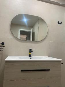 a bathroom with a sink and a mirror at Castel Málaga Home in Málaga
