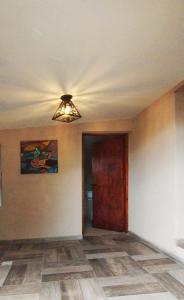 an empty room with a ceiling fan and a door at Ecos del Alma - Casas de Campo in Tupungato