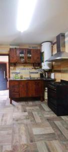 a kitchen with wooden cabinets and a counter top at Ecos del Alma - Casas de Campo in Tupungato