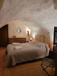 a bedroom with a large bed with two towels on it at Maison In Vino in Nyons