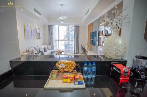 a living room with a table with food on it at Dunya tower Royal suite Burj Khalifa street, Kings in Dubai