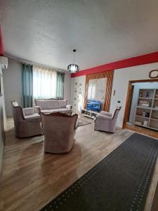 a living room with couches and chairs in a room at The house of dreams 2 in Shkodër